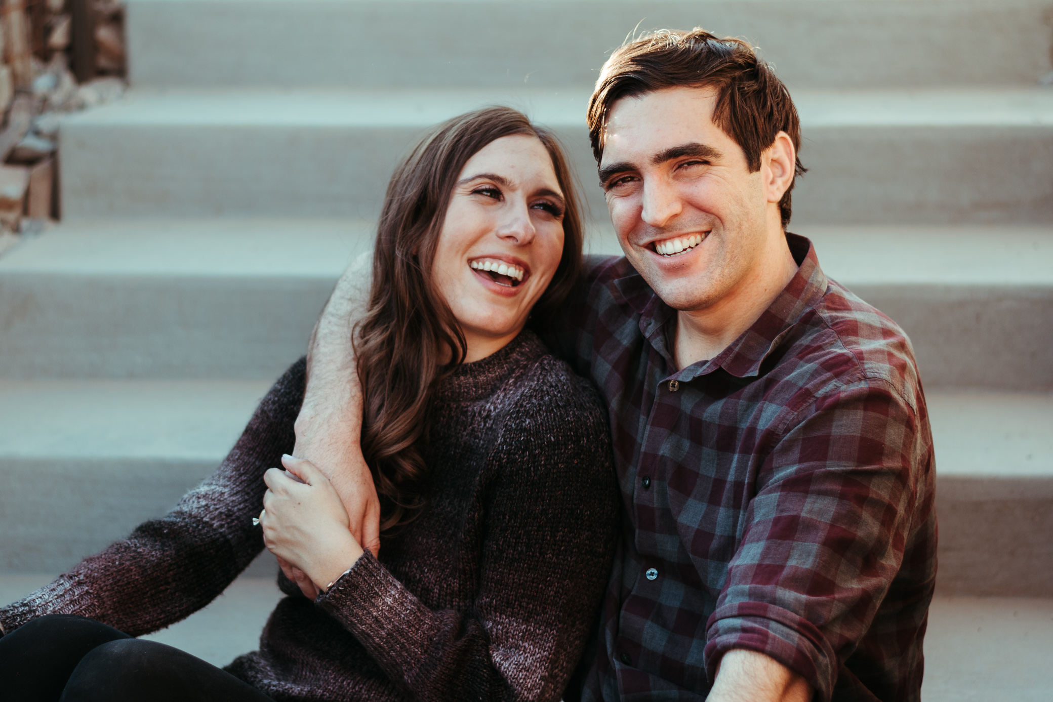 Engaged couple sitting on the stairs at Piestewa Peak in Phoenix, Arizona