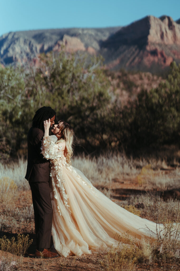 Eloping couple about to kiss in a field in Sedona, Arizona.